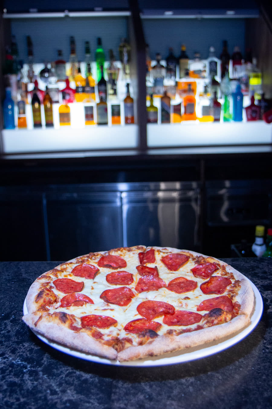 Pepperoni pizza in the Les Trois Monkeys restaurant setting.